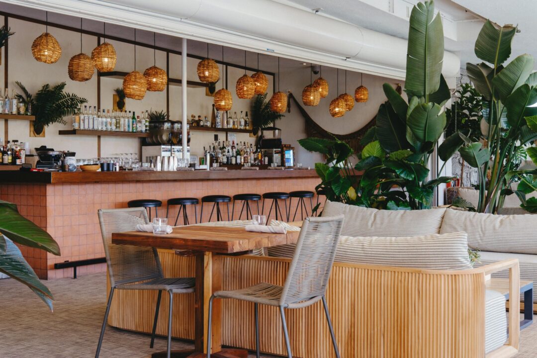 Tropical restaurant and bar interior with wooden seating
