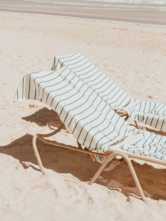 two lounge chairs at the beach